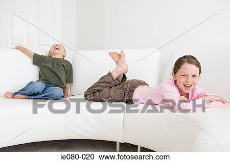 Children relaxing on sofa View Large Photo Image Stock Image - Children relaxing on sofa. Fotosearch