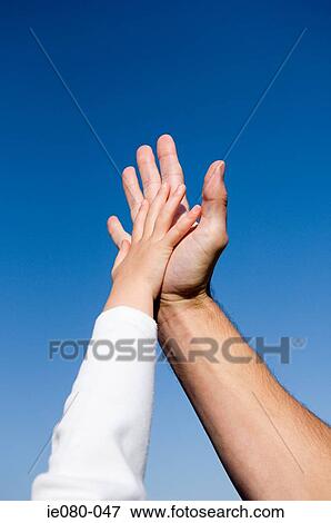 Stock Photo - Childs hand on an adults hand. Fotosearch