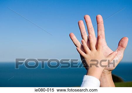 Childs hand on an adults hand View Large Photo Image Stock Photography - Childs hand on an adults hand. Fotosearch