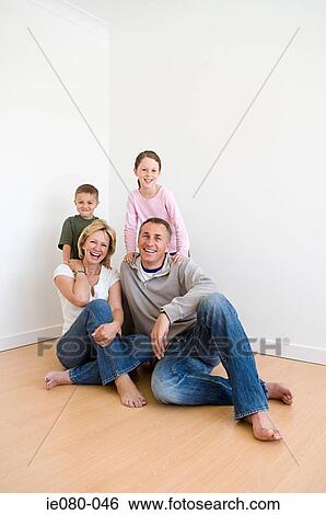 Family sitting on the floor View Large Photo Image Stock Photograph - Family sitting on the floor. Fotosearch