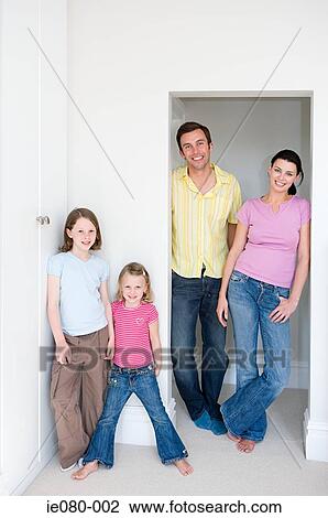 Family standing in a doorway View Large Photo Image Stock Image - Family standing in a doorway. Fotosearch