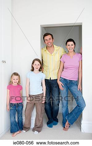 Stock Photograph - Family standing in a doorway. Fotosearch
