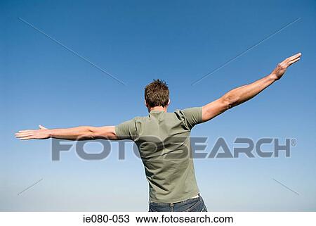 Man standing with arms open View Large Photo Image Stock Image - Man standing with arms open. Fotosearch