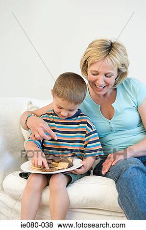 Mother and son eating biscuits View Large Photo Image Stock Photo - Mother and son eating biscuits. Fotosearch