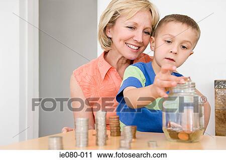 Mother counting coins with son View Large Photo Image Stock Image - Mother counting coins with son. Fotosearch