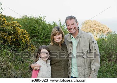 Parents standing with their daughter View Large Photo Image Stock Image - Parents standing with their daughter. Fotosearch