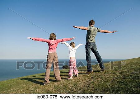 People standing on edge of hill View Large Photo Image Stock Photography - People standing on edge of hill. Fotosearch