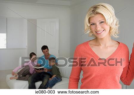 Woman in living room with family View Large Photo Image Stock Image - Woman in living room with family. Fotosearch
