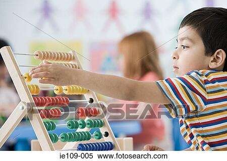 A boy counting on abacus View Large Photo Image Stock Photography - A boy counting on abacus. Fotosearch