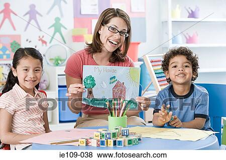 Stock Photo - A portrait of a teacher and children. Fotosearch