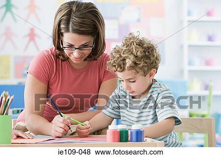 A teacher with a boy drawing View Large Photo Image Stock Photo - A teacher with a boy drawing. Fotosearch