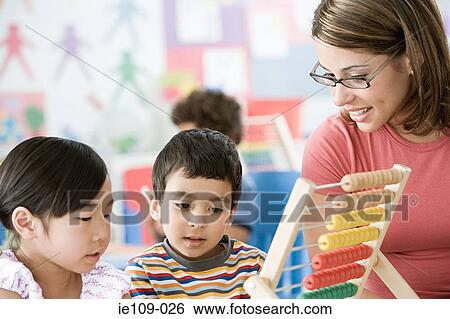 A teacher with two children View Large Photo Image Stock Photograph - A teacher with two children. Fotosearch