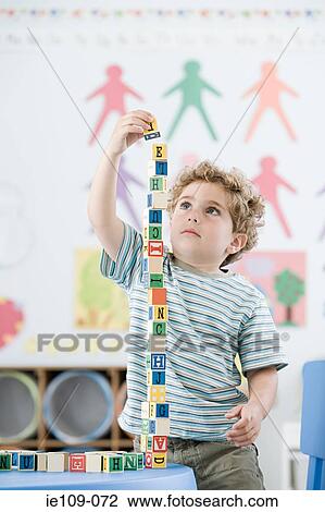 Boy playing with building blocks View Large Photo Image Stock Image - Boy playing with building blocks. Fotosearch
