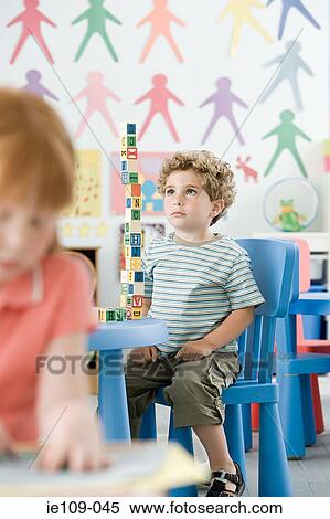 Boy playing with building blocks View Large Photo Image Stock Photography - Boy playing with building blocks. Fotosearch