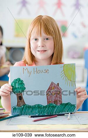 Girl holding up a picture View Large Photo Image Stock Photo - Girl holding up a picture. Fotosearch