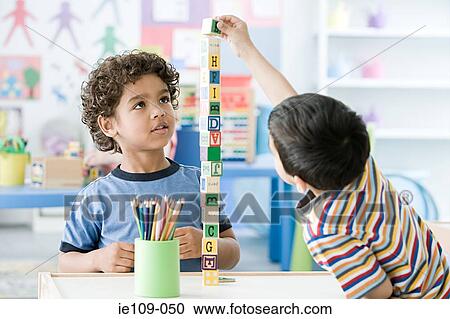 Two boys playing with building blocks View Large Photo Image Stock Image - Two boys playing with building blocks. Fotosearch