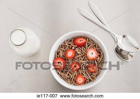 Stock Photo - A bowl of cereal and a bottle of milk. Fotosearch