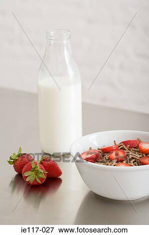 A bowl of cereal and a bottle of milk View Large Photo Image Stock Photo - A bowl of cereal and a bottle of milk. Fotosearch