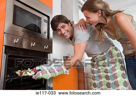 A couple cooking food View Large Photo Image Stock Image - A couple cooking food. Fotosearch