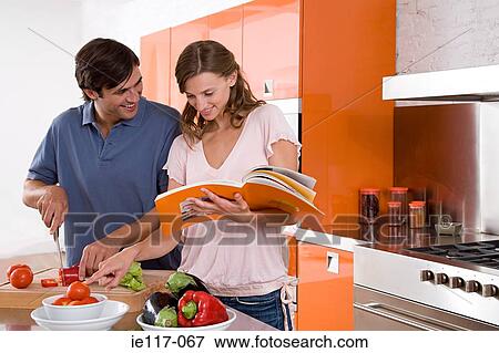 Stock Photo - A couple reading a cookbook. Fotosearch