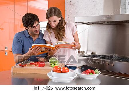 A couple reading a cookbook View Large Photo Image Stock Photography - A couple reading a cookbook. Fotosearch