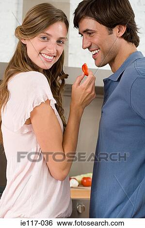 A woman feeding a man vegetables View Large Photo Image Stock Photograph - A woman feeding a man vegetables. Fotosearch
