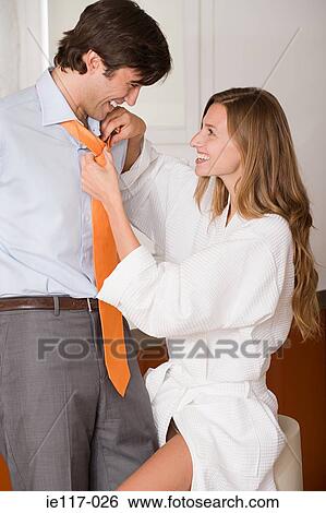 A woman tying a mans tie View Large Photo Image Stock Photograph - A woman tying a mans tie. Fotosearch