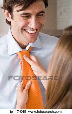 A woman tying a mans tie View Large Photo Image Stock Photography - A woman tying a mans tie. Fotosearch