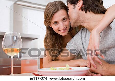 Man kissing a woman on the cheek View Large Photo Image Picture - Man kissing a woman on the cheek. Fotosearch