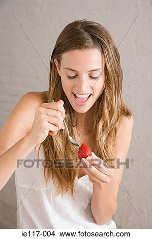 Woman holding a strawberry View Large Photo Image Picture - Woman holding a strawberry. Fotosearch