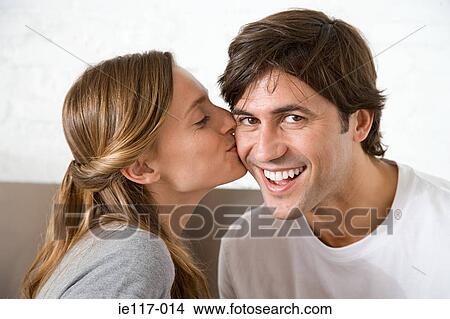 Woman kissing man on the cheek View Large Photo Image Picture - Woman kissing man on the cheek. Fotosearch