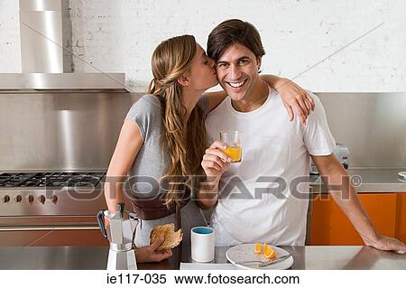 Woman kissing man on the cheek View Large Photo Image Stock Photography - Woman kissing man on the cheek. Fotosearch