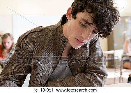 Stock Image - Boy studying at college. Fotosearch