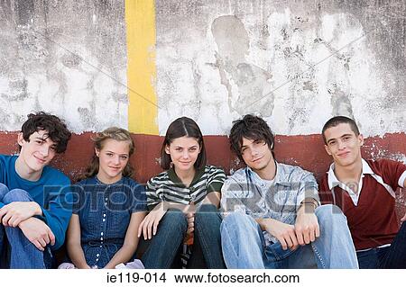 Five teenagers sitting in a row View Large Photo Image Picture - Five teenagers sitting in a row. Fotosearch
