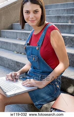 Girl using a laptop computer on steps View Large Photo Image Stock Image - Girl using a laptop computer on steps. Fotosearch