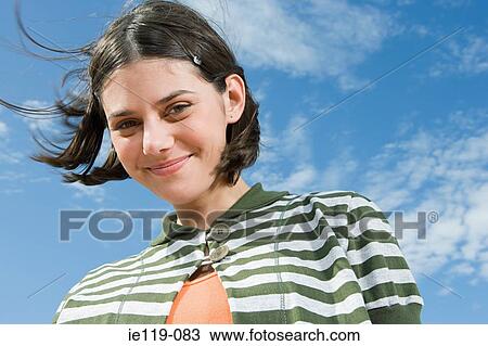 Smiling girl against blue sky View Large Photo Image Stock Image - Smiling girl against blue sky. Fotosearch