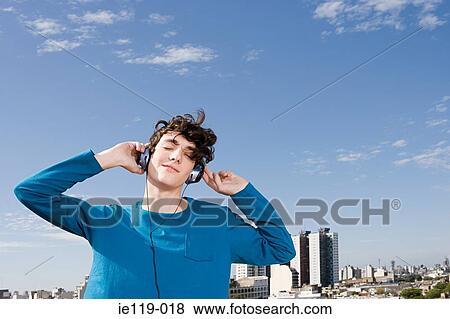 Teenage boy listening to music View Large Photo Image Stock Photo - Teenage boy listening to music. Fotosearch