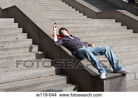 Teenage boy using a cellular telephone View Large Photo Image Picture - Teenage boy using a cellular telephone. Fotosearch