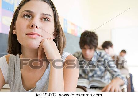 Stock Image - Teenagers in a classroom. Fotosearch