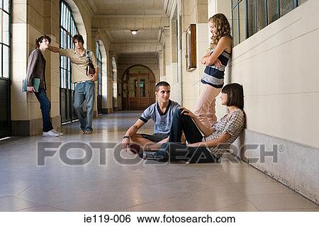 Teenagers in a college corridor View Large Photo Image Stock Photograph - Teenagers in a college corridor. Fotosearch