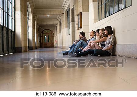 Teenagers sitting in a coridor View Large Photo Image Stock Photograph - Teenagers sitting in a coridor. Fotosearch