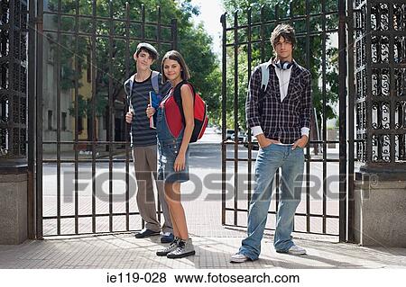 Three high school students near a gate View Large Photo Image Stock Photo - Three high school students near a gate. Fotosearch