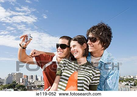 Three teenage friends taking photographs View Large Photo Image Stock Image - Three teenage friends taking photographs. Fotosearch