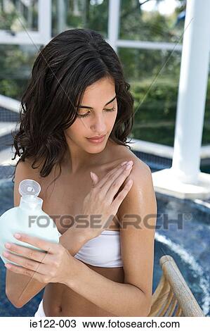 Woman applying body lotion View Large Photo Image Stock Image - Woman applying body lotion. Fotosearch