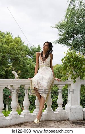 Woman sitting on balcony View Large Photo Image Stock Image - Woman sitting on balcony. Fotosearch