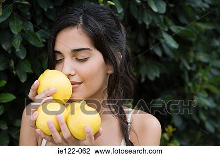 Woman smelling lemons View Large Photo Image Stock Image - Woman smelling lemons. Fotosearch