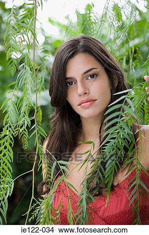 Young woman amongst leaves View Large Photo Image Picture - Young woman amongst leaves. Fotosearch