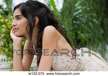 Young woman daydreaming View Large Photo Image Stock Photography - Young woman daydreaming. Fotosearch