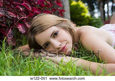 Young woman resting in garden View Large Photo Image Stock Image - Young woman resting in garden. Fotosearch