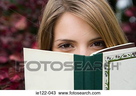 Young woman with a book View Large Photo Image Stock Image - Young woman with a book. Fotosearch